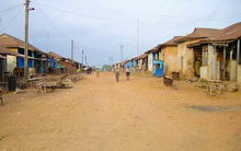 Dusty road lined with small houses