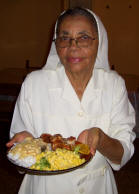 Sister Milagros holding plate of food