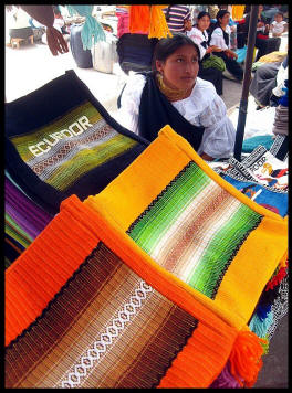 Fabrics in market with woman sitting behind