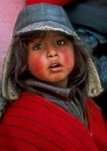 Young boy in warm hat with ruddy cheeks