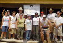 Team posing in front of Habitat house