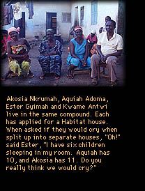 Four people sitting in a housing compound