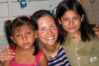 Jenny posing with two young girls
