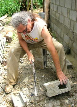 Volunteer cutting concrete block