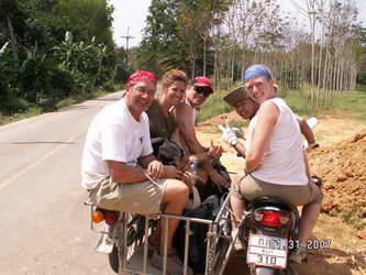 Team members riding on the local Habitat affiliate's construction vehicle