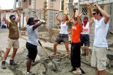Neighbor played YMCA, and team broke from making cement to dance