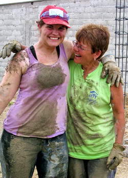 Two volunteers after a day of messy cement work