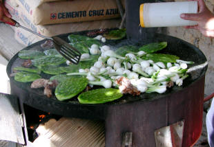 Nopales & onions cooking on a grill