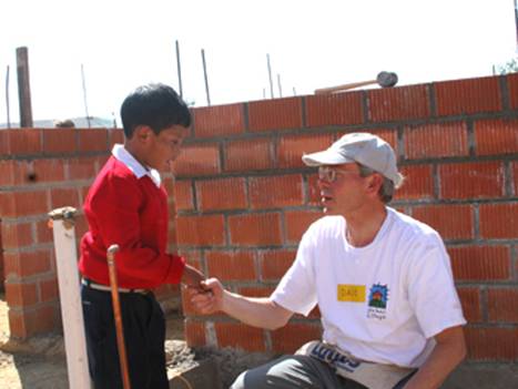 Volunteer talking with small boy