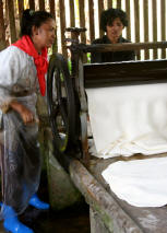 Two women processing rubber