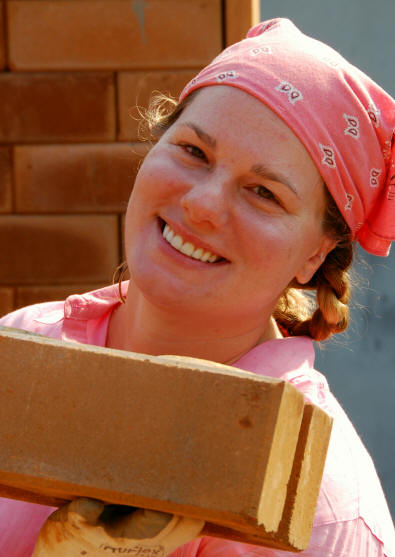 Smiling volunteer holding brick