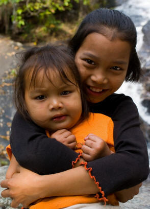 Young girl holding younger child