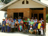 Volunteers and locals in front of house