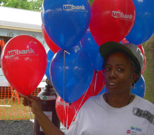 African American woman amidst balloons with the US Bank logo