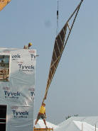 Truss being lifted onto a house under construction